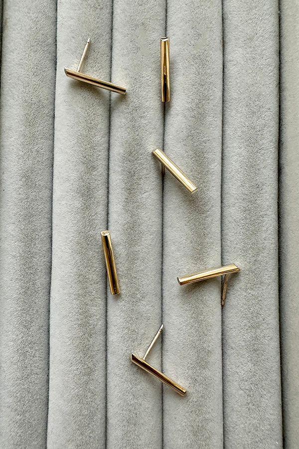 Edge Only 9 carat gold D Bar Earrings on grey velvet. 100% recycled gold