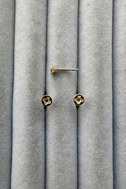Edge Only mini Cross-head screw earrings in solid 100% recycled 14 carat gold on grey velvet