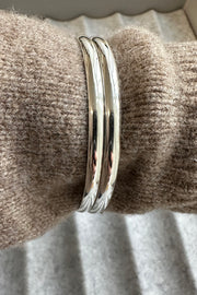 pair of Edge Only 4.5mm Bangles sterling silver, on sweater