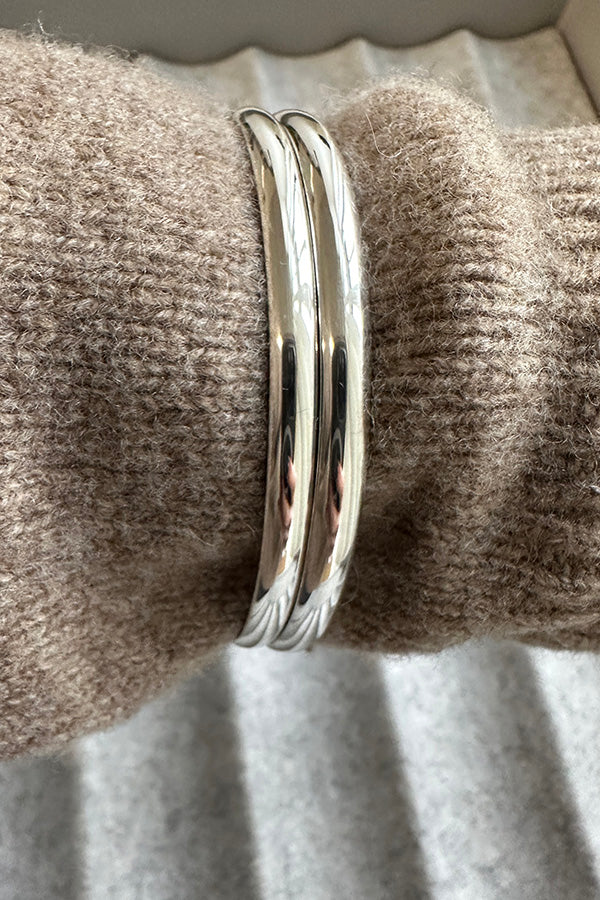pair of Edge Only 4.5mm Bangles sterling silver, on sweater