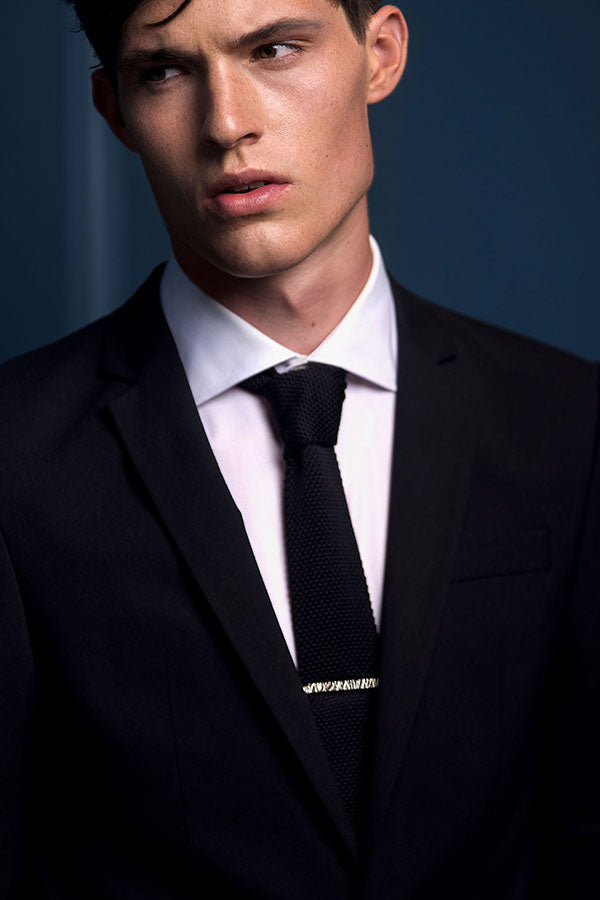 Edge Only Rugged Tie Bar in recycled sterling silver. Worn on a black suit and knitted black tie.