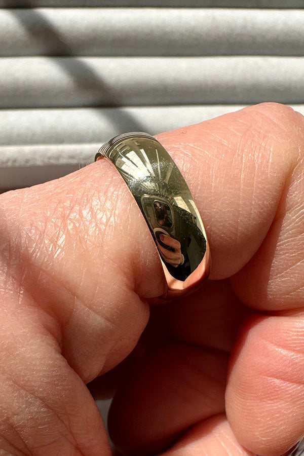 Edge Only 9ct gold 6mm D Shaped Band on index finger. 100% recycled gold
