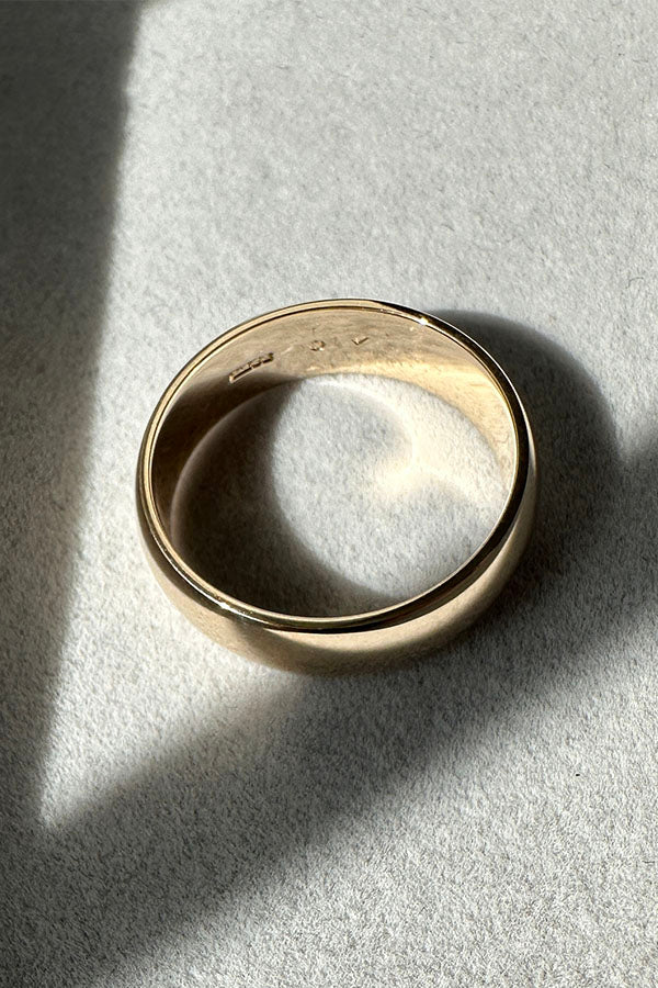 Edge Only 9ct gold 6mm D Shaped Band flat in grey velvet tray. 100% recycled gold
