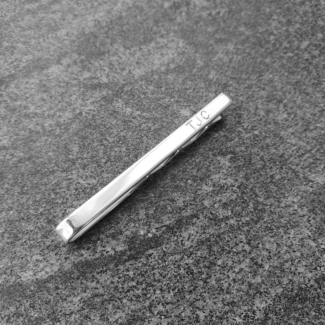 Hand Engraved Initials added to the front of an Edge Only polished sterling silver tie bar.  Right aligned.