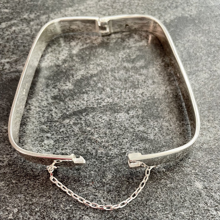 Edge Only Hinged Rectangular Bangle in sterling silver open with safety chain